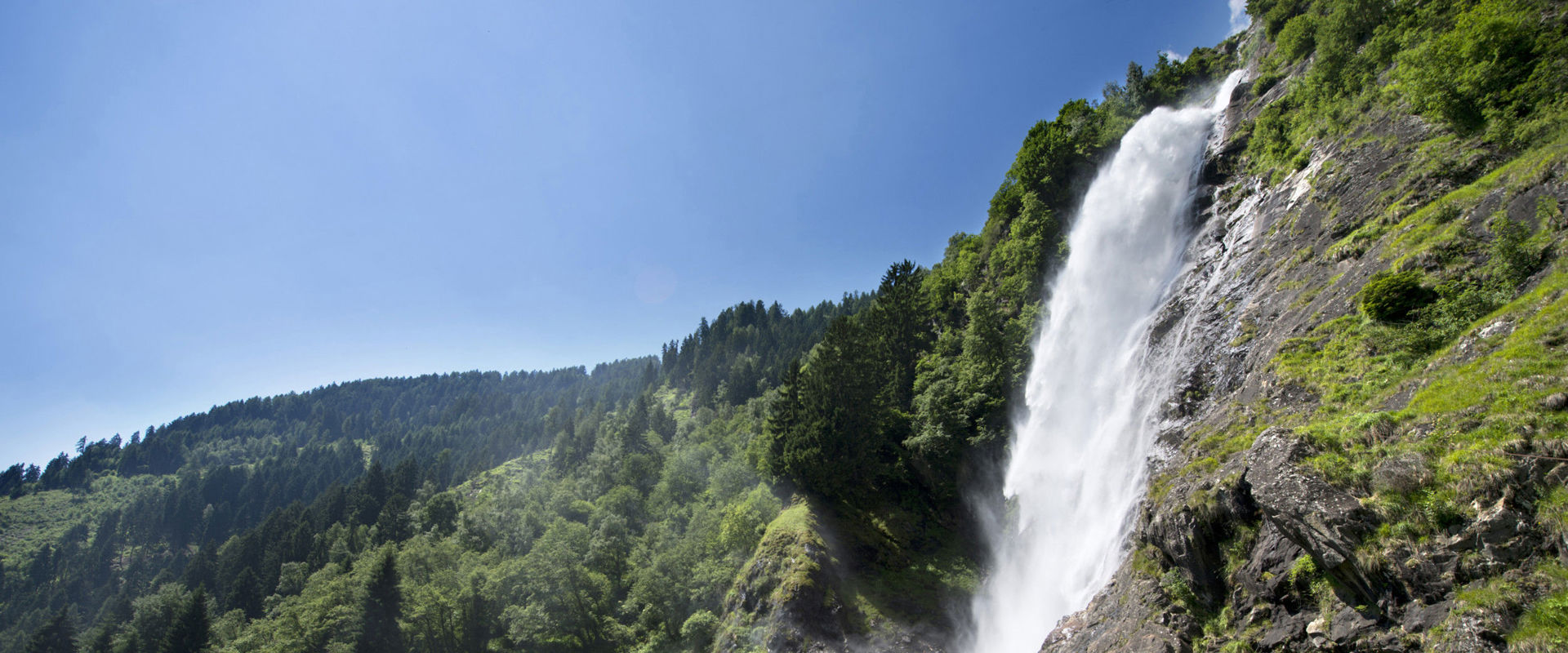 Partschins waterfall Breathtaking waterfall in the midst of green meadows and dense forests.