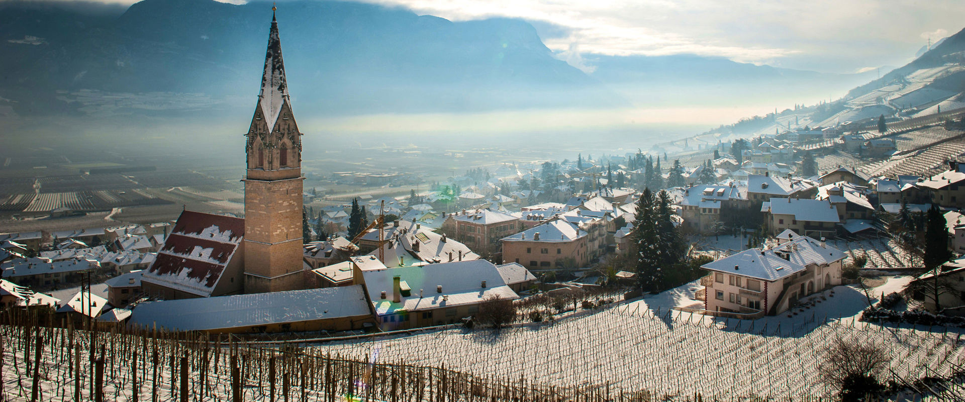 Tramin in winter Tramin in winter with a breathtaking view of the Tramin parish church and the snow-covered landscape of the lowlands.